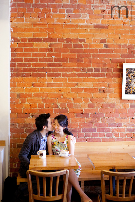 a photo of a couple kissing at an e-shoot at manic coffee toronto